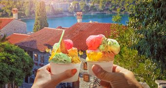 Couple with beautiful bright sweet ice cream of different flavors in the hand